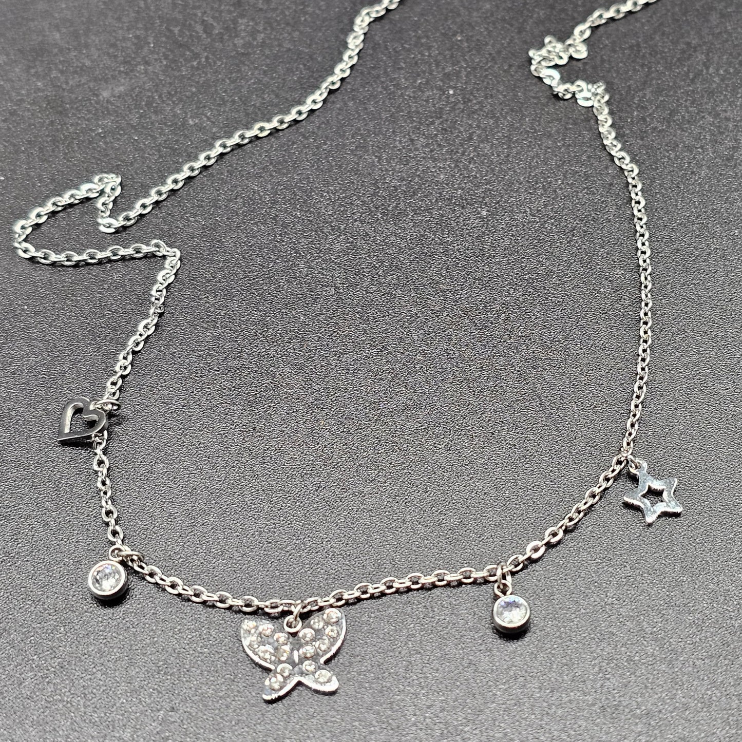 Collier argenté en acier – maille forçat fine, pampilles papillon & strass