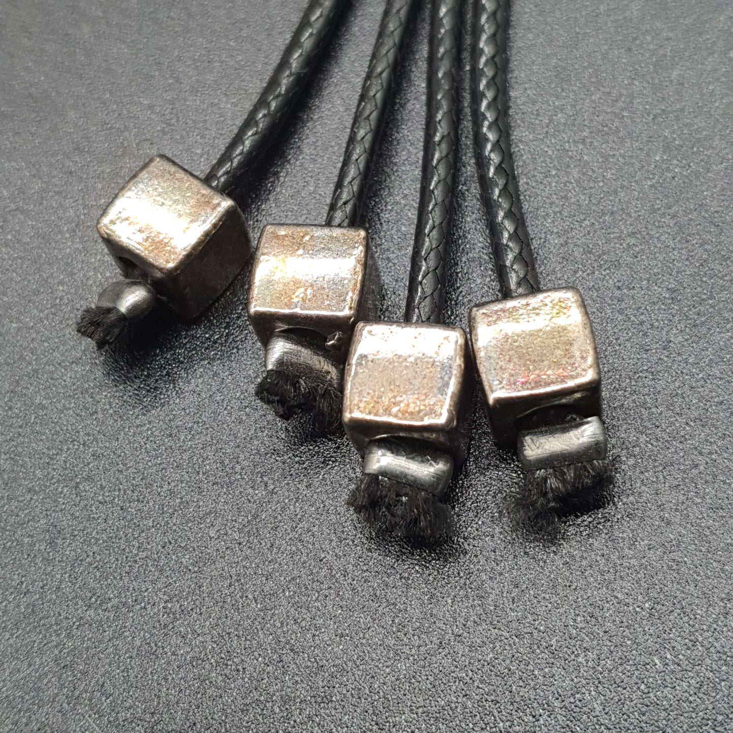 Long necklace with double waxed cotton cord, fabric flower petals, cube metal beads. Long necklace with fabric flower petals, silver-plated cube metal beads – double black waxed cotton cord.