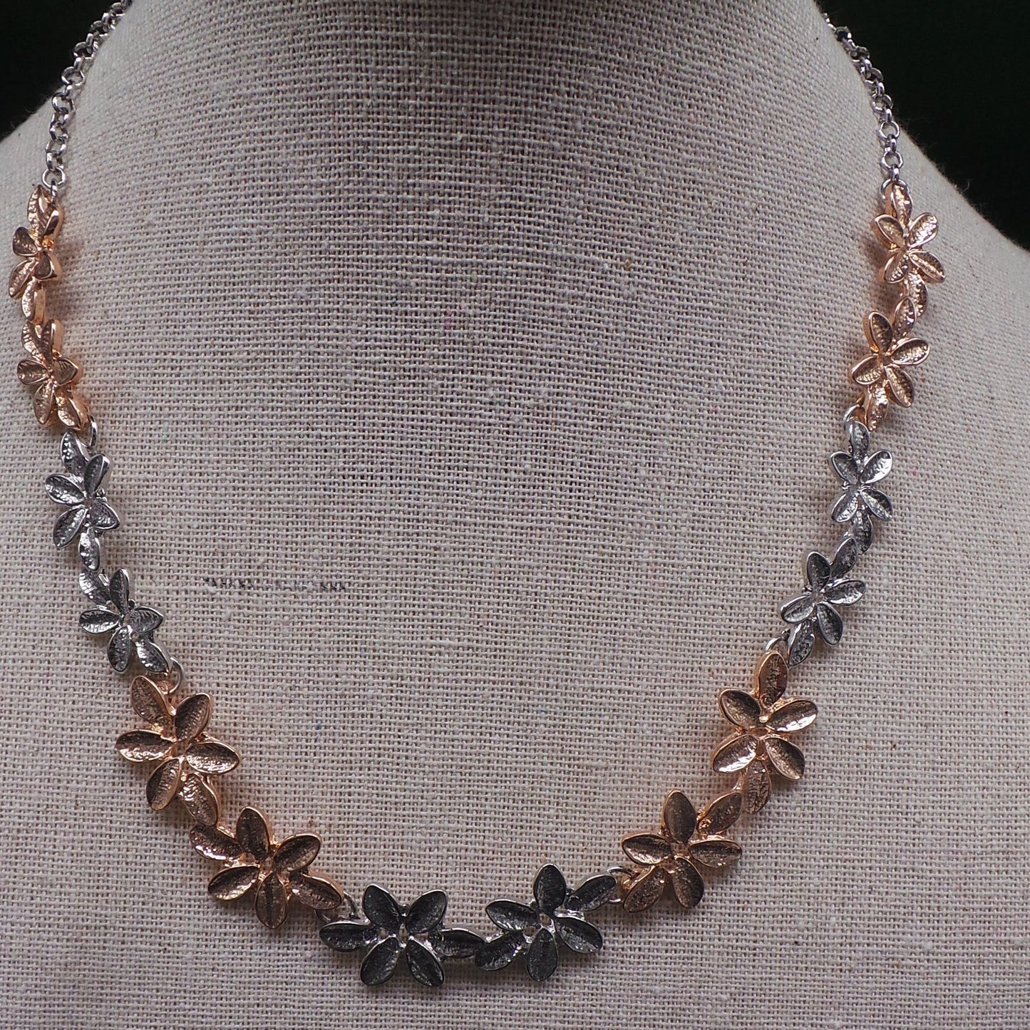 Gold and silver-tone flower necklace on an adjustable chain