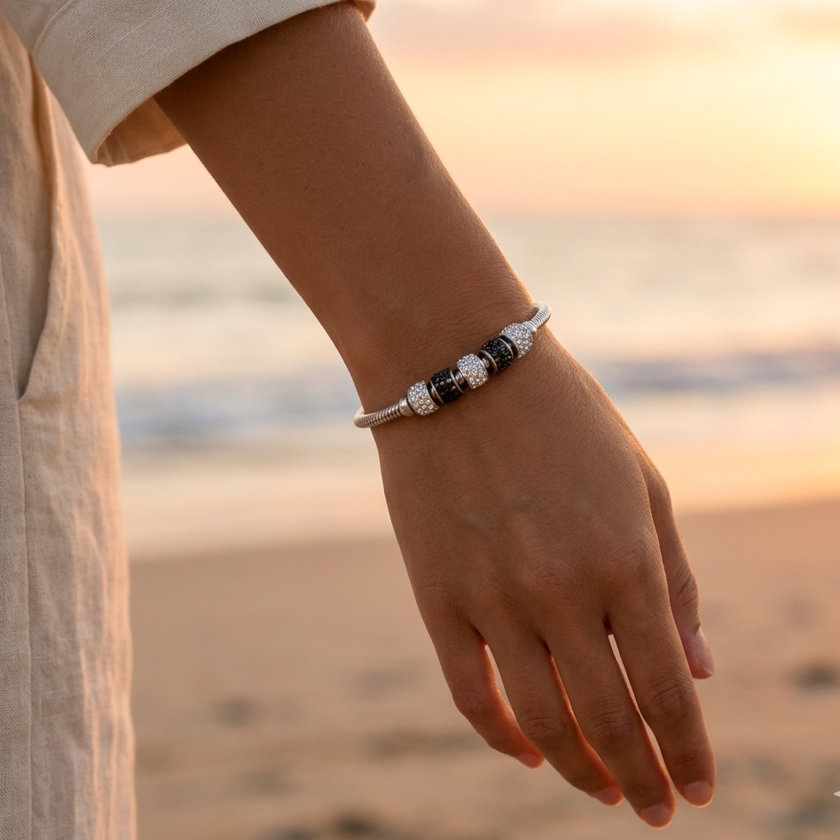 Silver-plated omega mesh magnetic bracelet with metal tubes, white rhinestones, and black crystal shards
