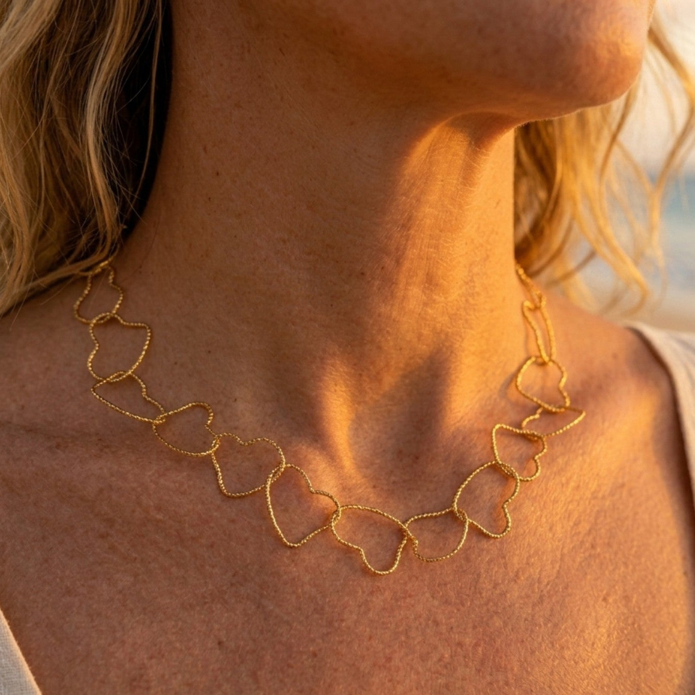 Gold-plated steel necklace, fine cable chain, intertwined hearts in gold-toned metal