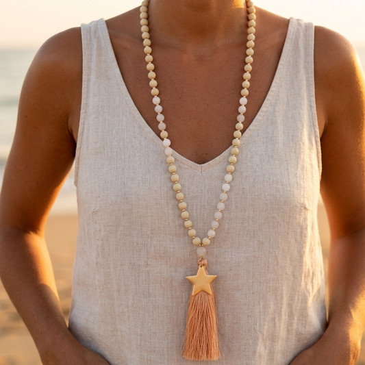 Long necklace with wooden beads, golden star, and tassel