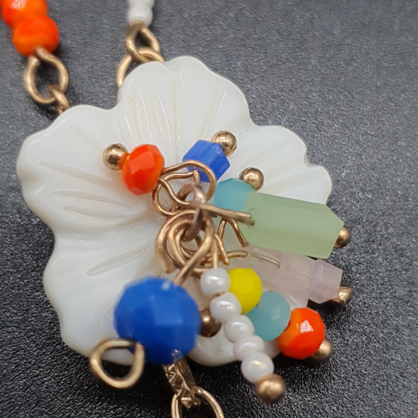 Collier sautoir double rang acier doré chaînes à billes maille gourmette perles fantaisie colorées pompon tassel pampille dorée pendentifs pierre reconstituée fleur en nacre chaînettes colorées