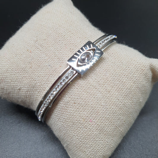 Bracelet jonc acier inoxydable argenté – œil mystique, strass et pièce rectangulaire