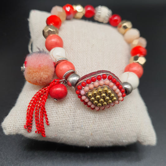 Bracelet  élastique perles rouges dorées pompon tassel