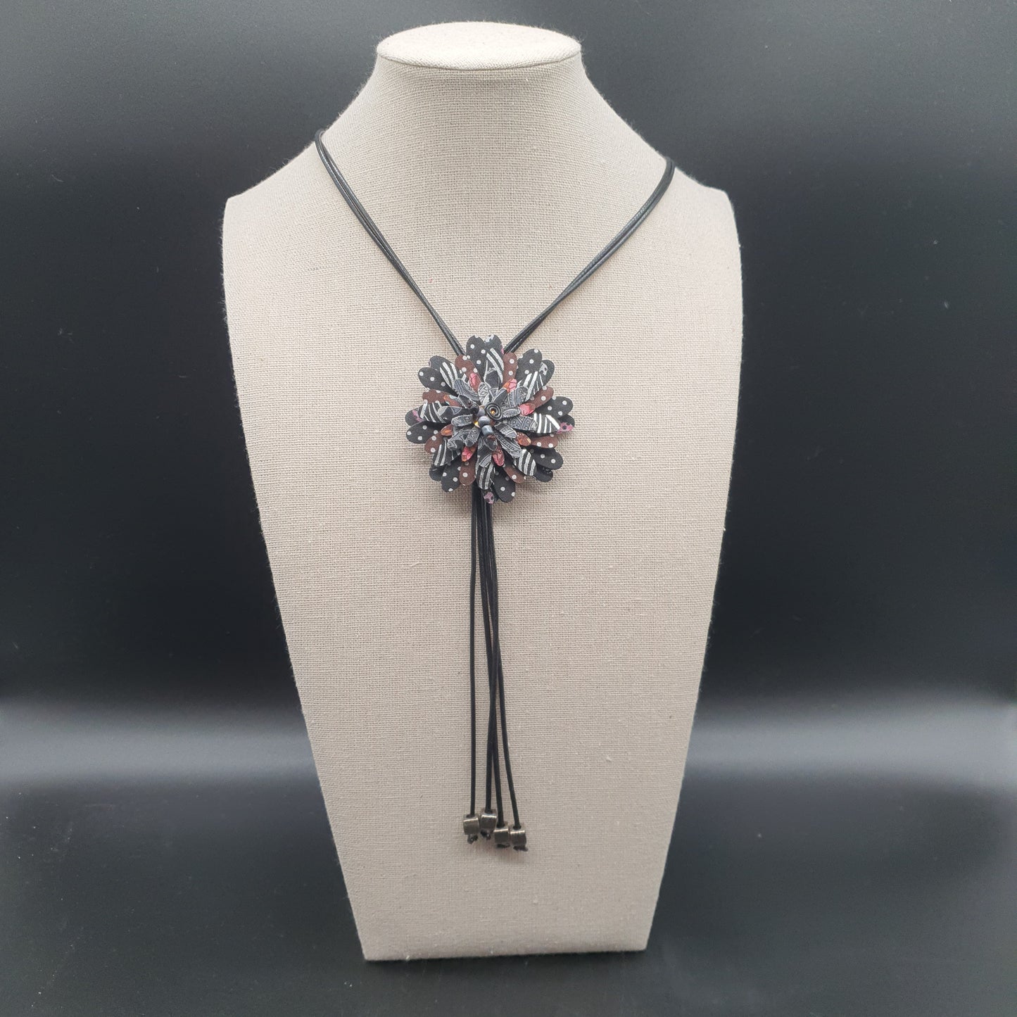 Long necklace with double waxed cotton cord, fabric flower petals, cube metal beads. Long necklace with fabric flower petals, silver-plated cube metal beads – double black waxed cotton cord.