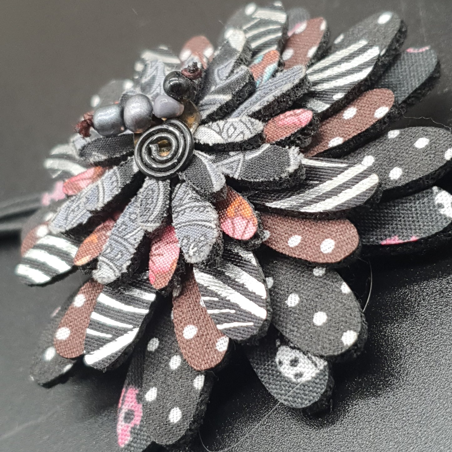 Long necklace with double waxed cotton cord, fabric flower petals, cube metal beads. Long necklace with fabric flower petals, silver-plated cube metal beads – double black waxed cotton cord.