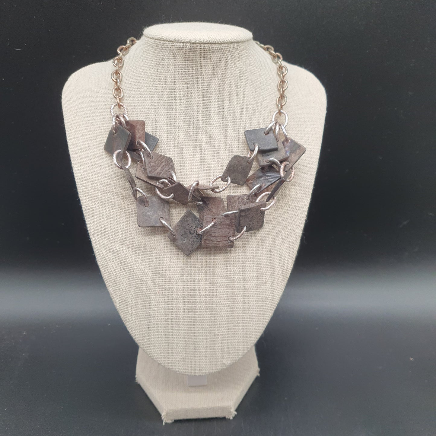 Triple-strand aged steel necklace with chunky links and geometric hammered lozenges