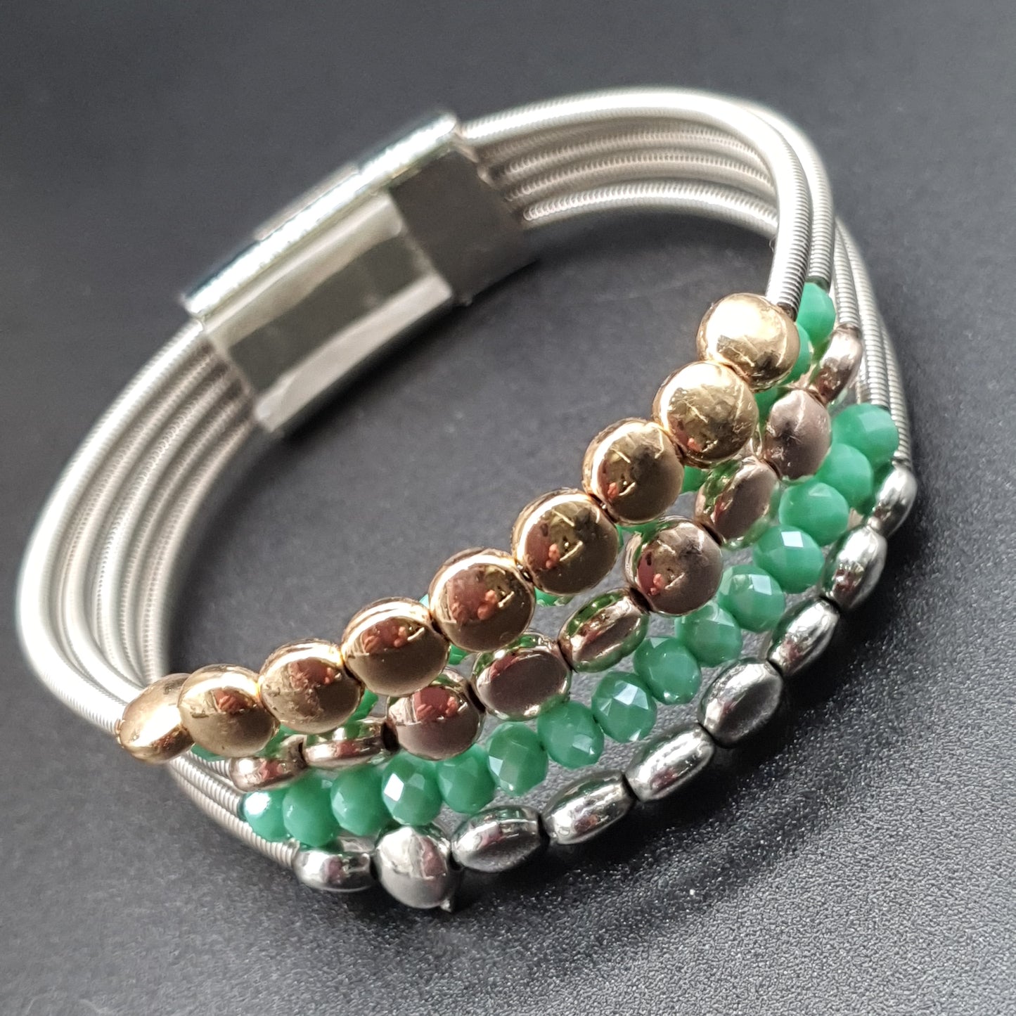 Multistrand magnetic necklace and bracelet set with fine spiraled cables, round silver and gold-tone metal pieces, and colorful crystal