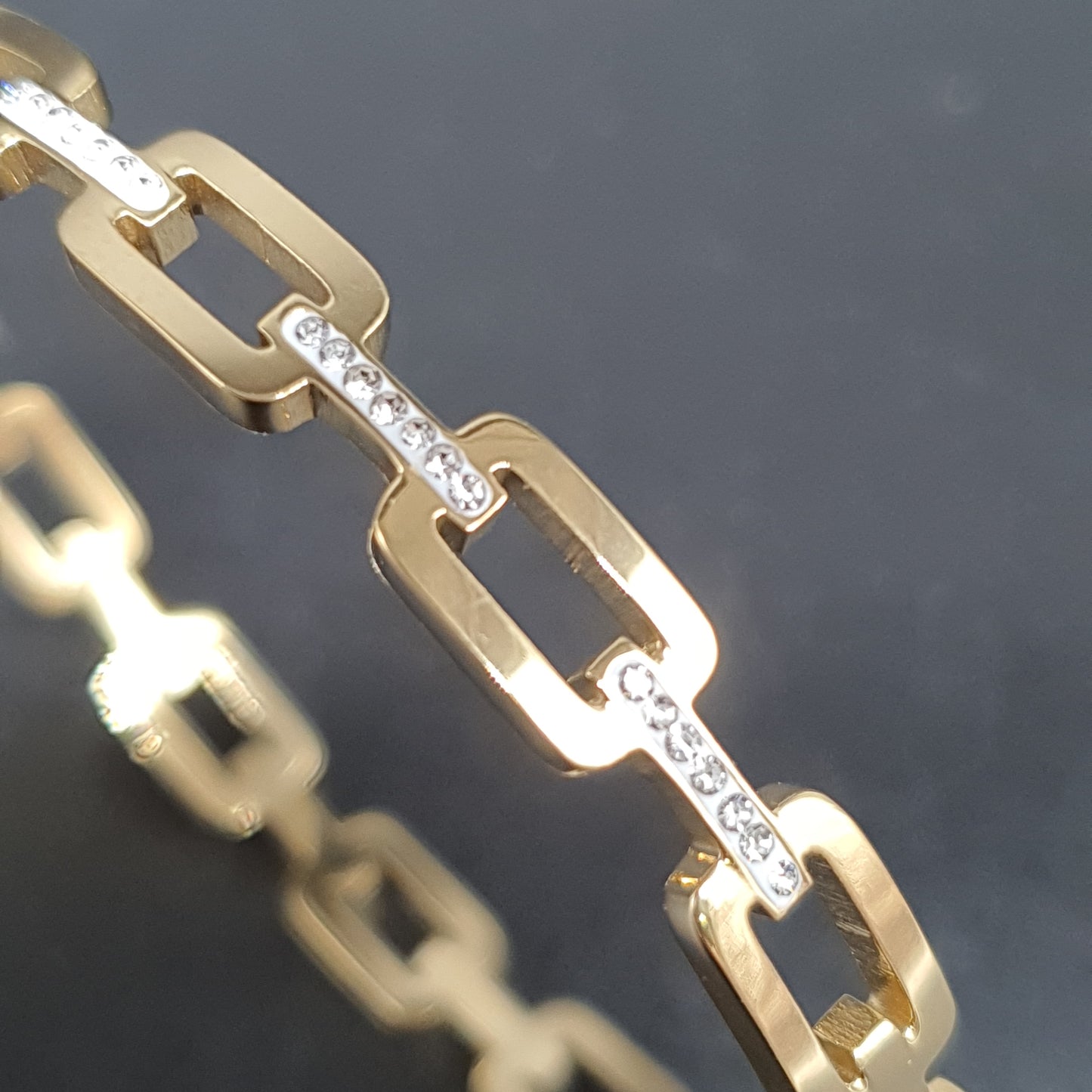 Gold-plated steel bangle bracelet – large rectangular links & brilliant rhinestones