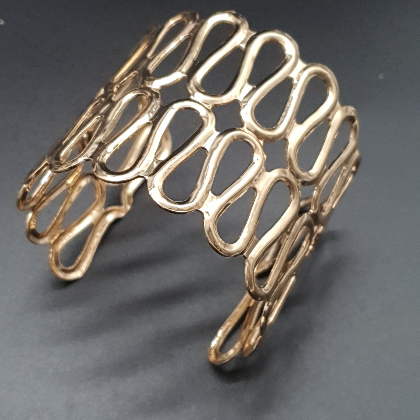 Openwork stainless steel cuff bracelet with wave pattern – gold or silver plated