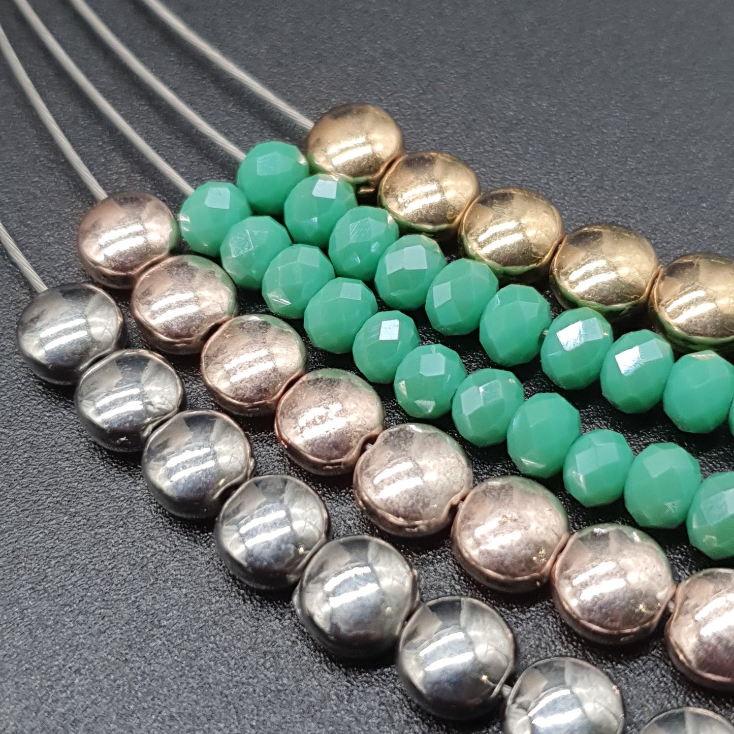 Multistrand magnetic necklace and bracelet set with fine spiraled cables, round silver and gold-tone metal pieces, and colorful crystal