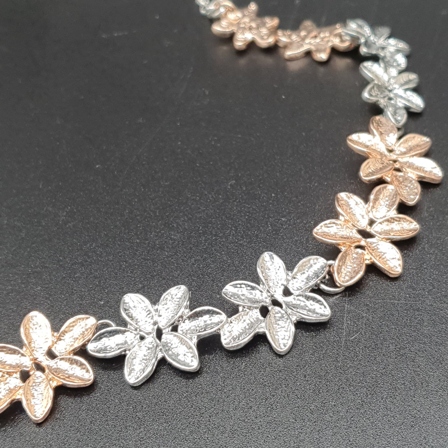 Gold and silver-tone flower necklace on an adjustable chain