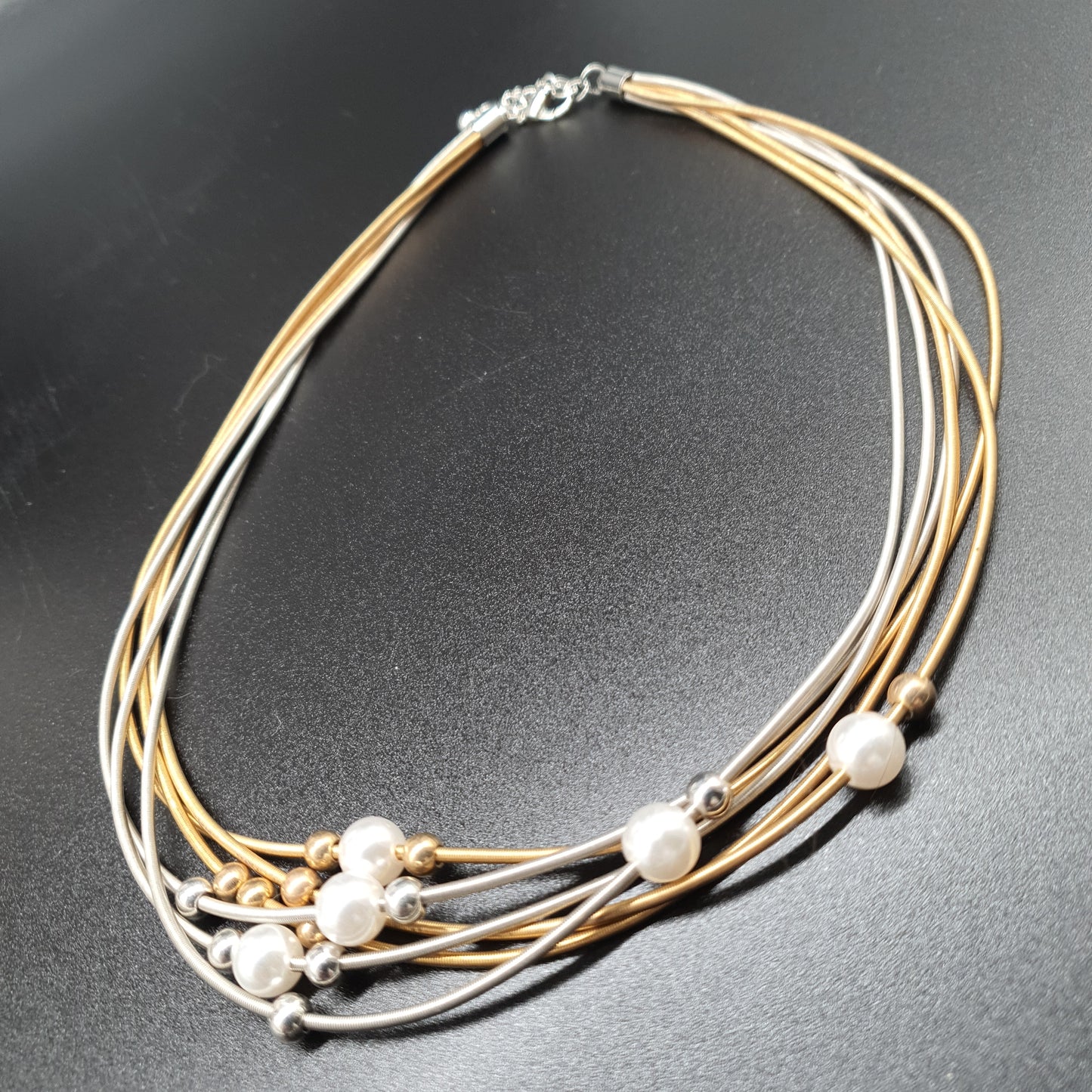 Multi-strand necklace with mother-of-pearl beads, silver- and gold-plated steel