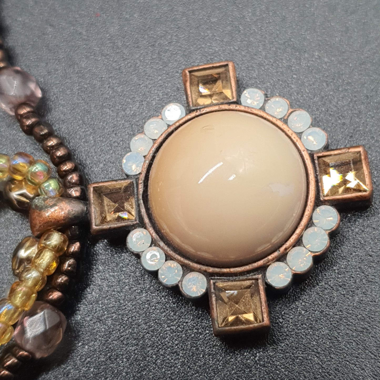 Triple strand gold necklace with faceted beads, enamel medallion & crystal rhinestones