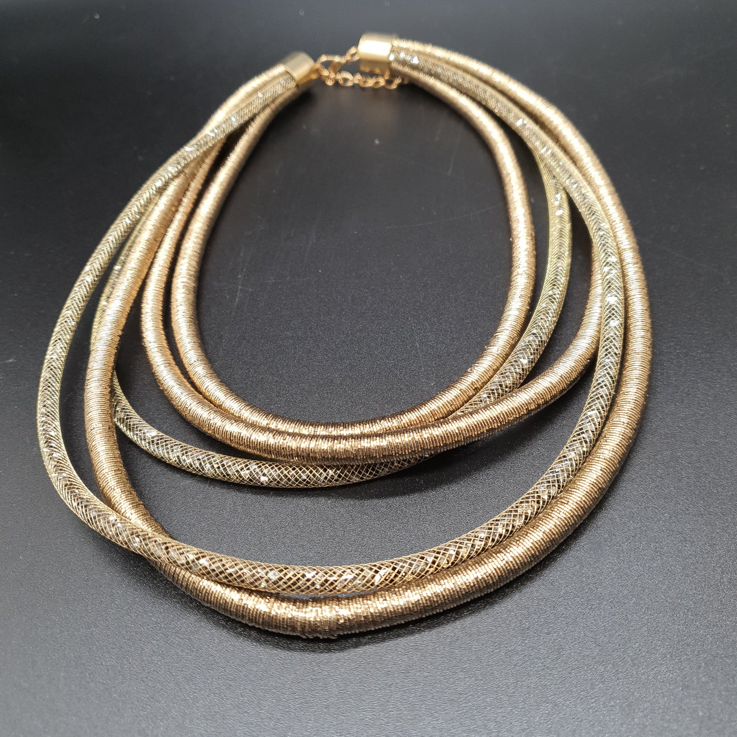 Beige multi-strand necklace with mesh tubes and crystal-effect metallic threads