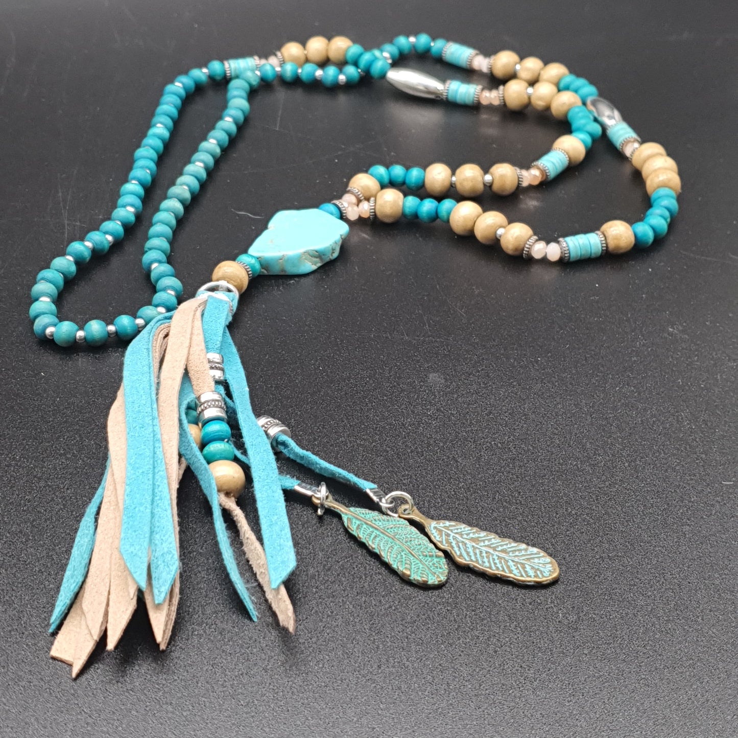Fancy long necklace with wooden beads, metal, round beads, washers, suede-effect tassel pompoms