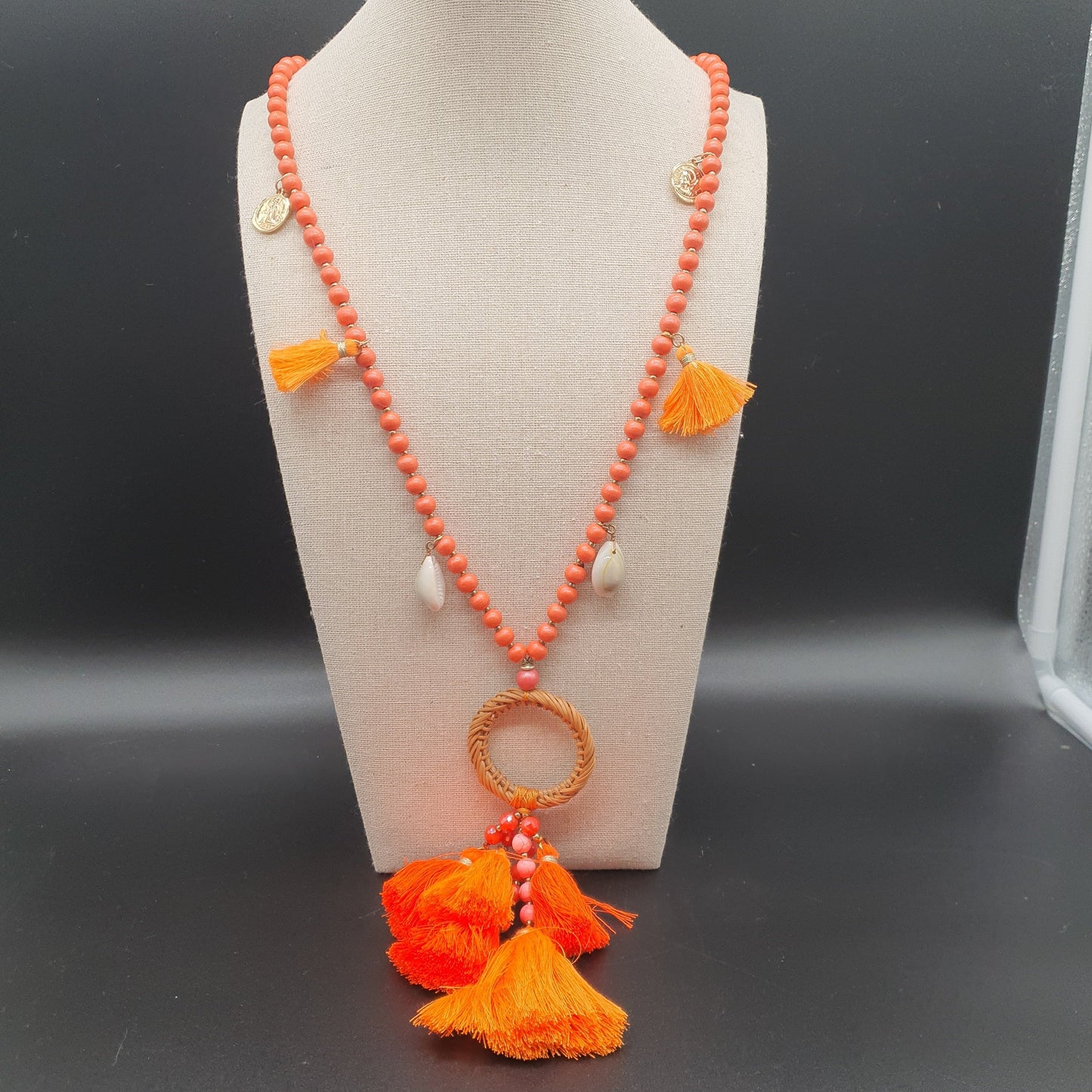 Orange long necklace with wooden beads, cowrie shells, gold medallions & cotton tassel
