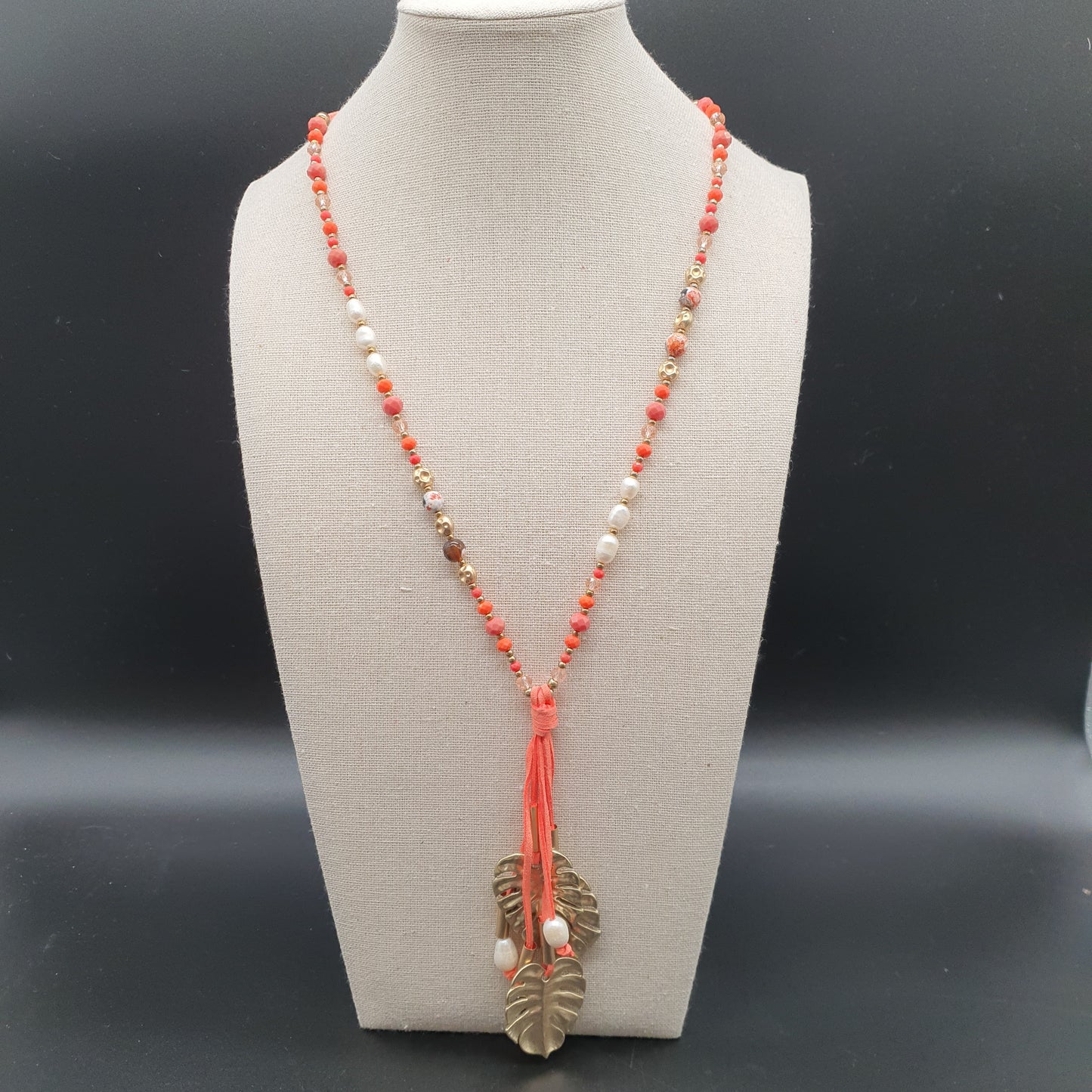 Long orange necklace in faux suede, mother-of-pearl beads, crystal, golden leaf pendant