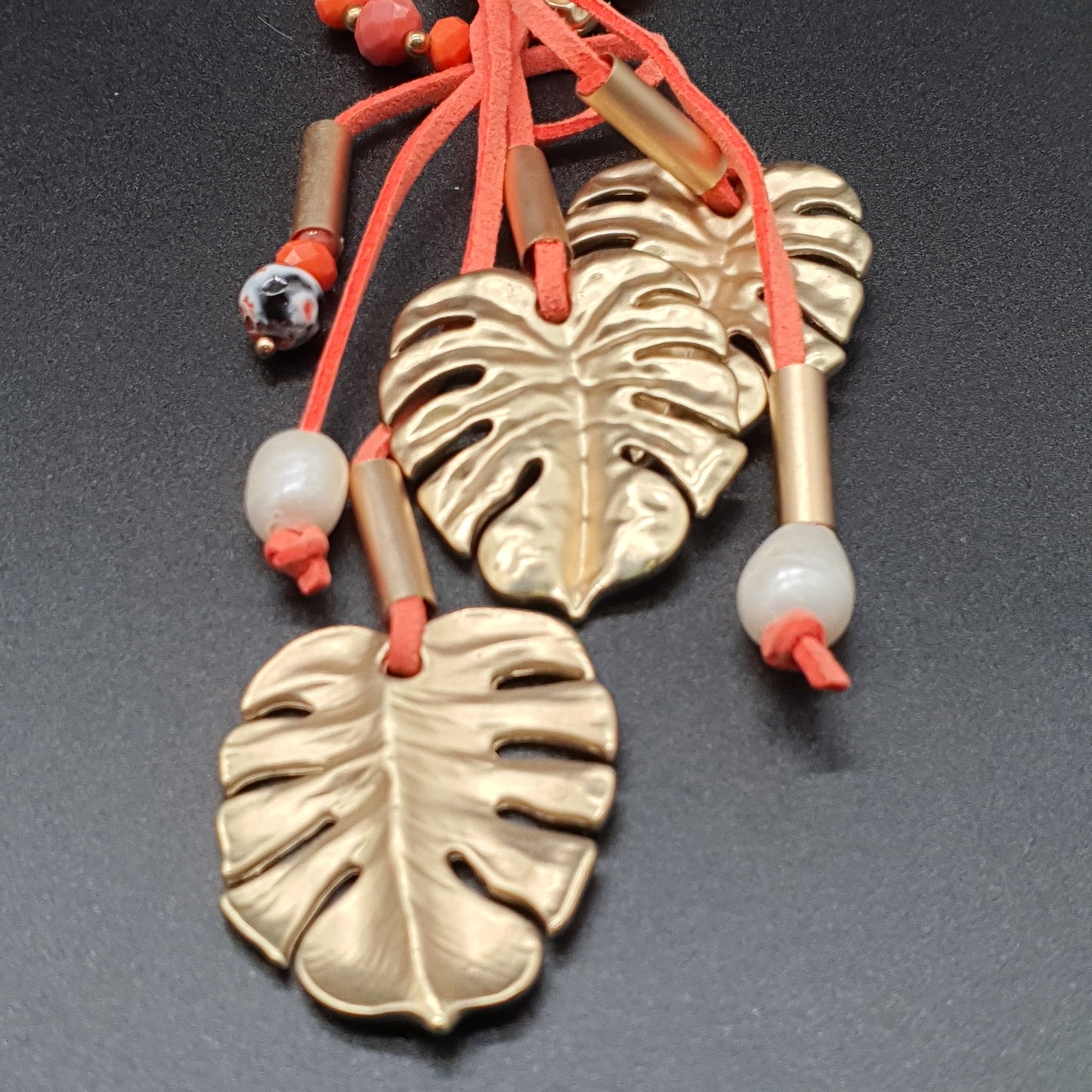 Long orange necklace in faux suede, mother-of-pearl beads, crystal, golden leaf pendant