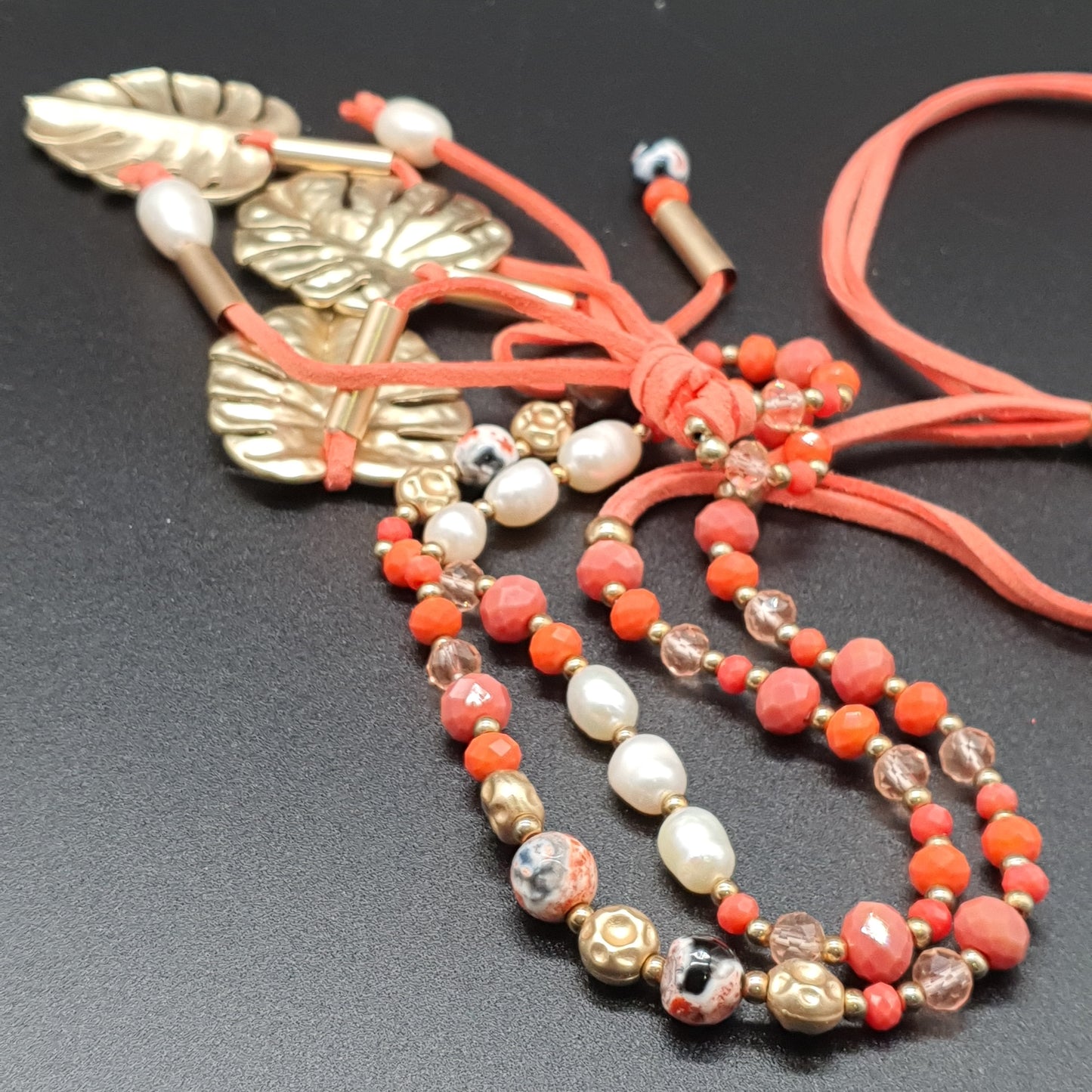 Long orange necklace in faux suede, mother-of-pearl beads, crystal, golden leaf pendant