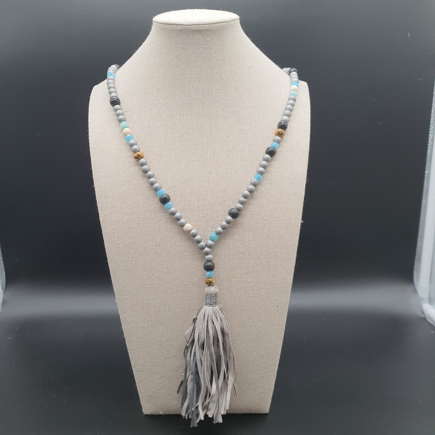 Long necklace with wood beads, reconstituted stones, and tassel pendant