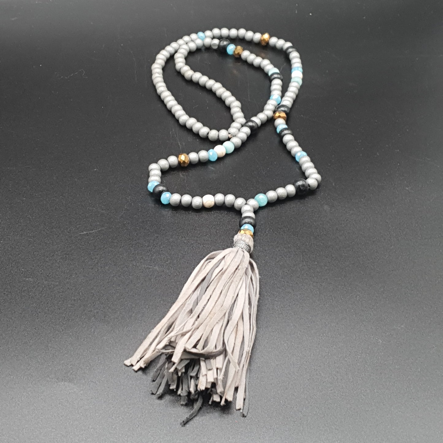 Long necklace with wood beads, reconstituted stones, and tassel pendant